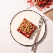 strawberry oatmeal bar on white plate with fork