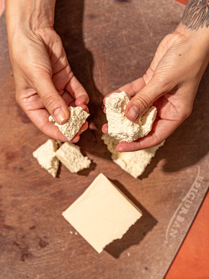 hand tearing tofu