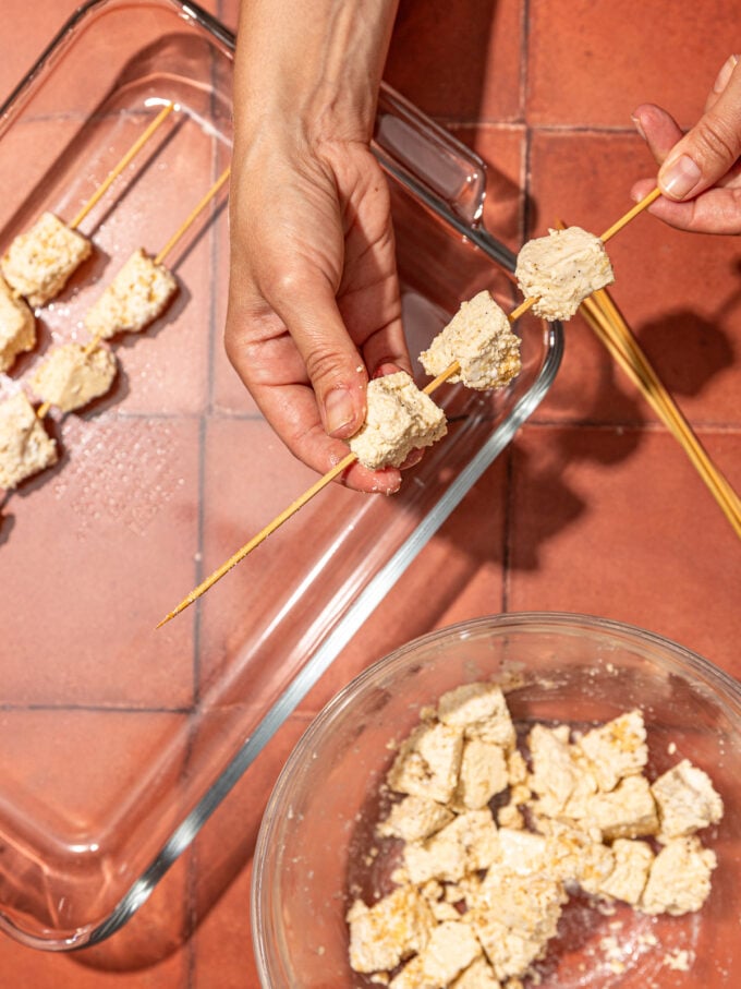 hand threading tofu skewers