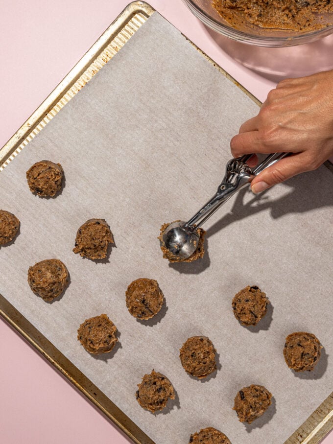 hand scooping chocolate chip cookies