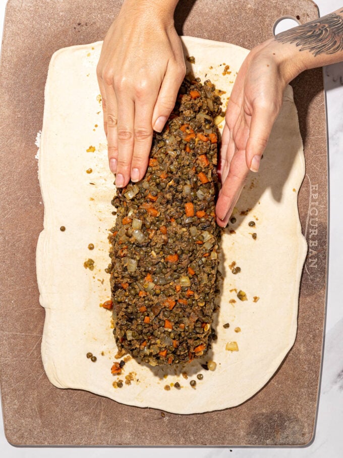 hands pressing lentil filling