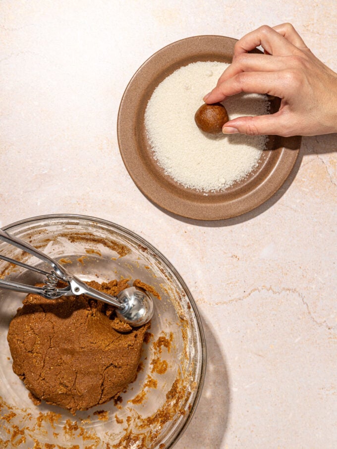 Hand rolling dough in sugar