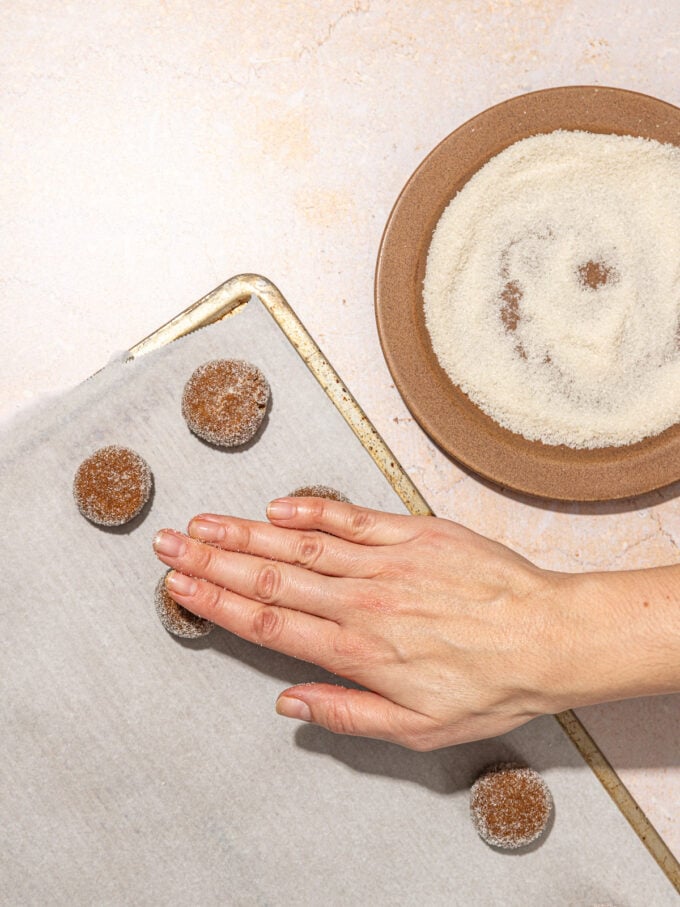 hand pressing ginger molasses cookies