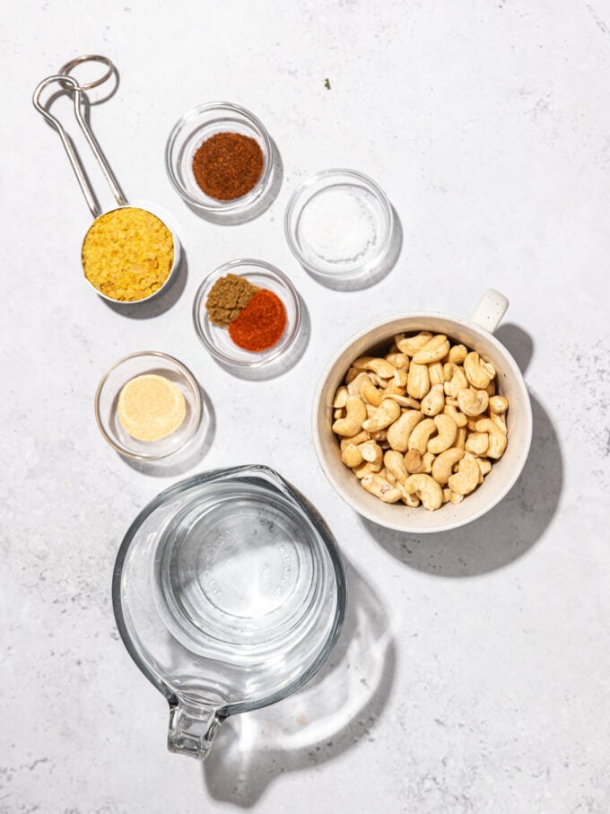 cashews, water and nutritional yeast in bowls