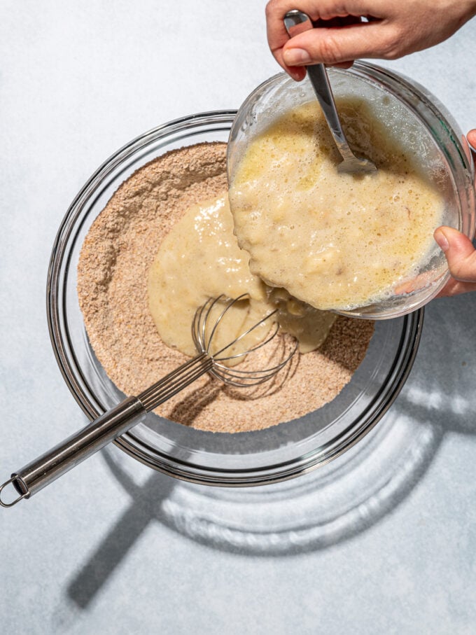 pouring banana mixture into flour mixture