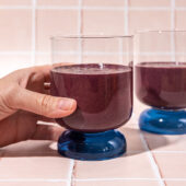 hand holding glass with chocolate cherry smoothie