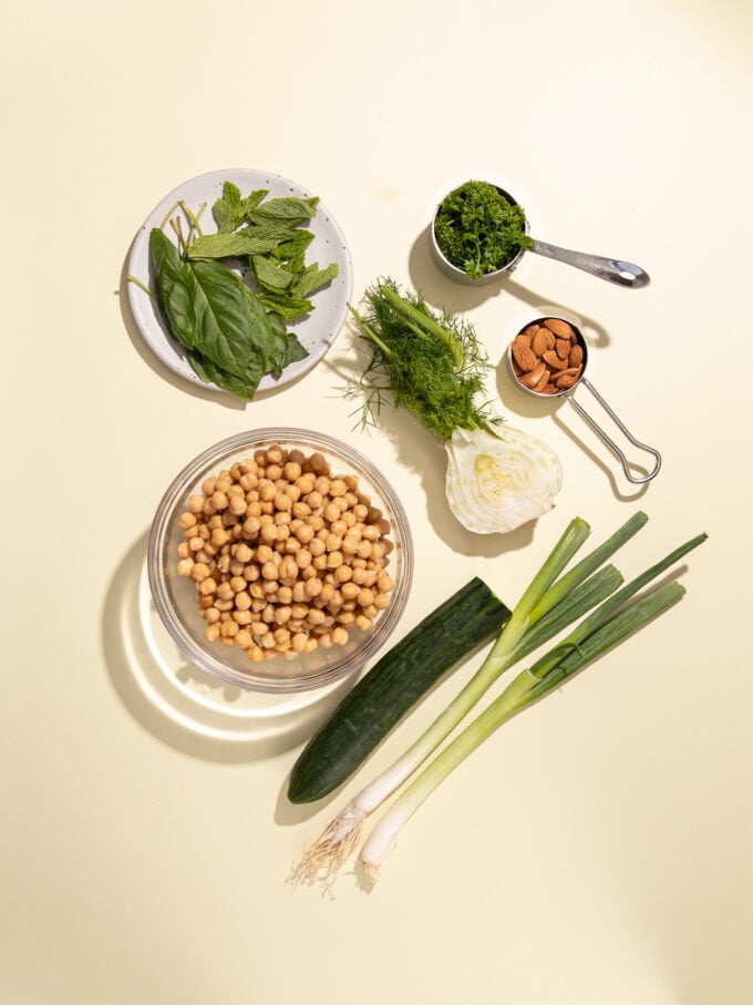 chickpeas in glass bowl with herbs, fennel, cucumber and green onion
