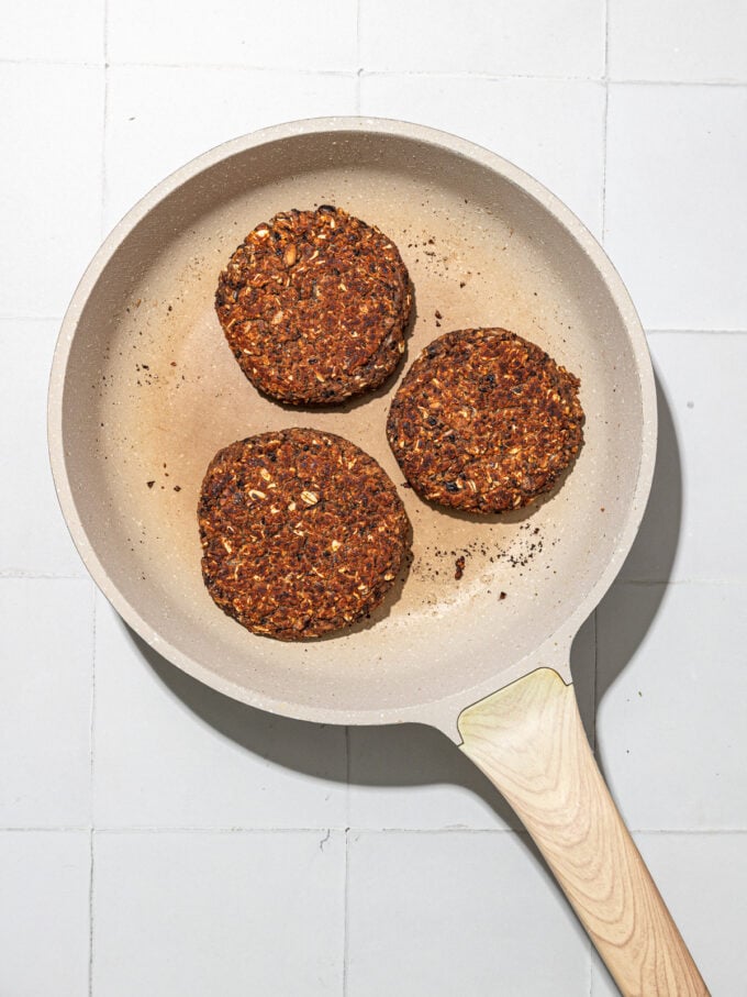 black bean burgers in beige skillet