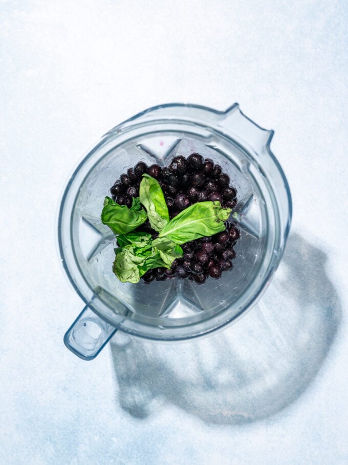 blueberries and basil in a blender