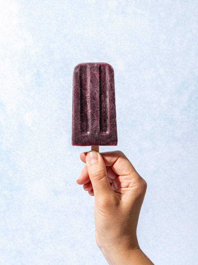 hand holding blueberry popsicle