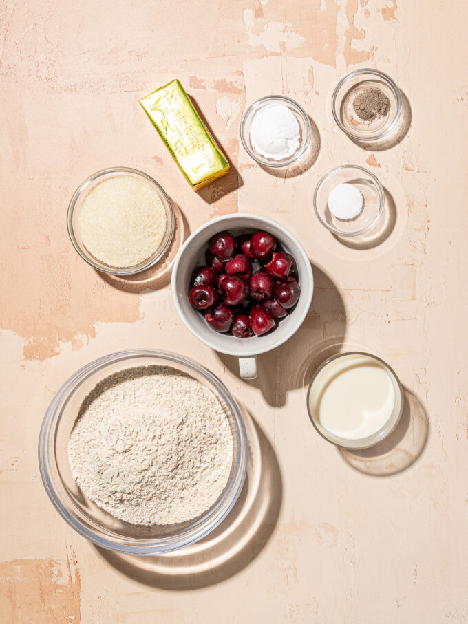 bowls of whole wheat flour, cherries, cardamom and soy milk