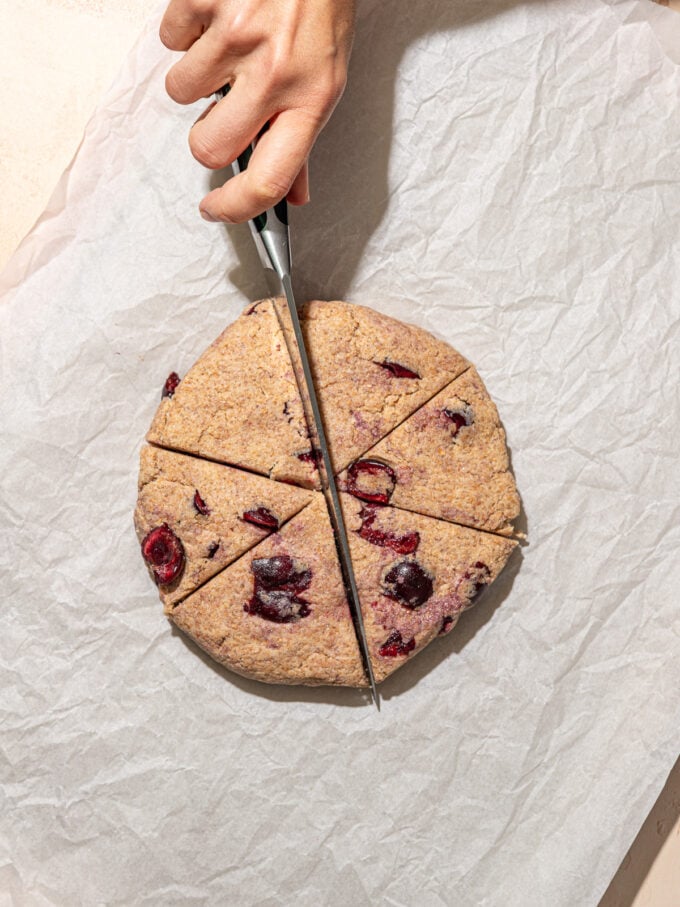 hand cutting cherry dough into wedges