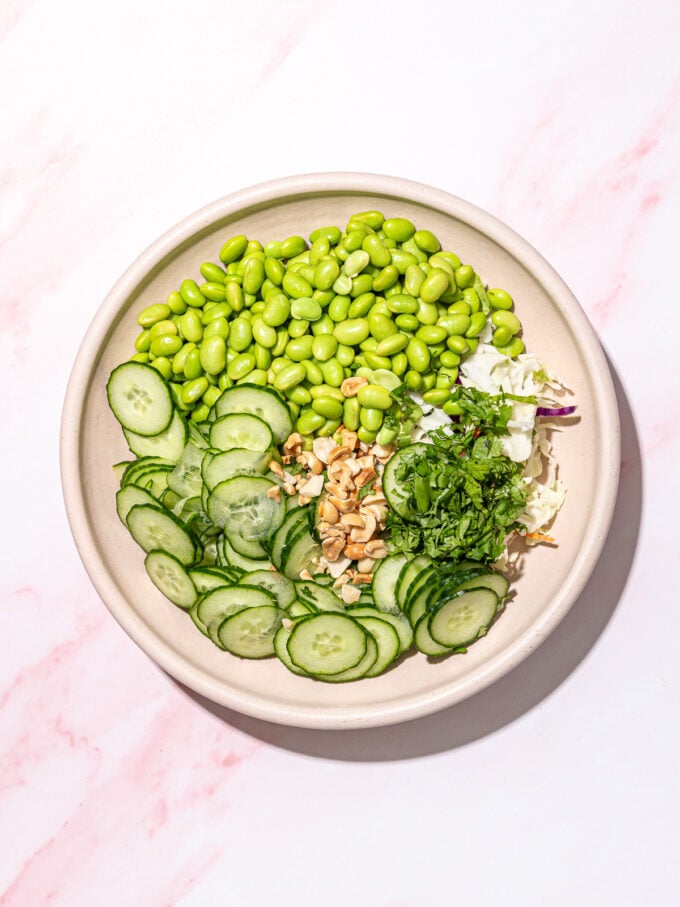 edamame, cucumber, peanuts and cilantro in white bowl
