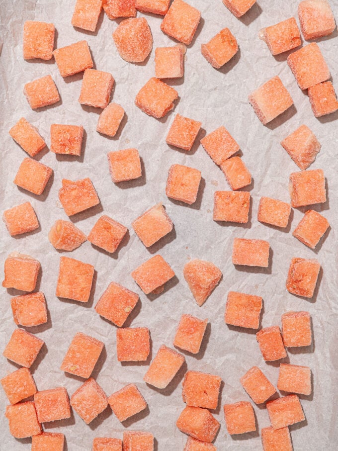 frozen watermelon cubes on parchment paper