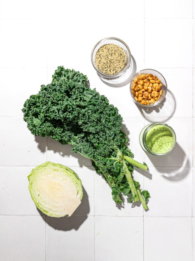 cabbage, kale, corn nuts, hemp hearts, green dressing in bowls