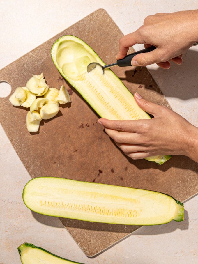 hand scooping zucchini