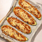 stuffed zucchini halves on baking sheet