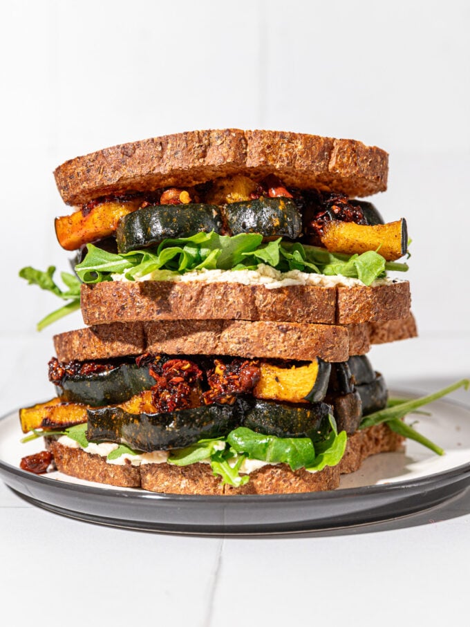 two squash sandwiches stacked on white and black plate