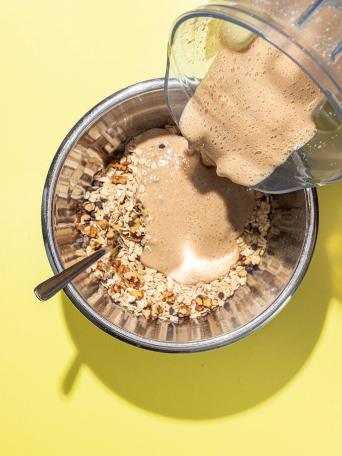 pouring blended liquid into bowl of oats